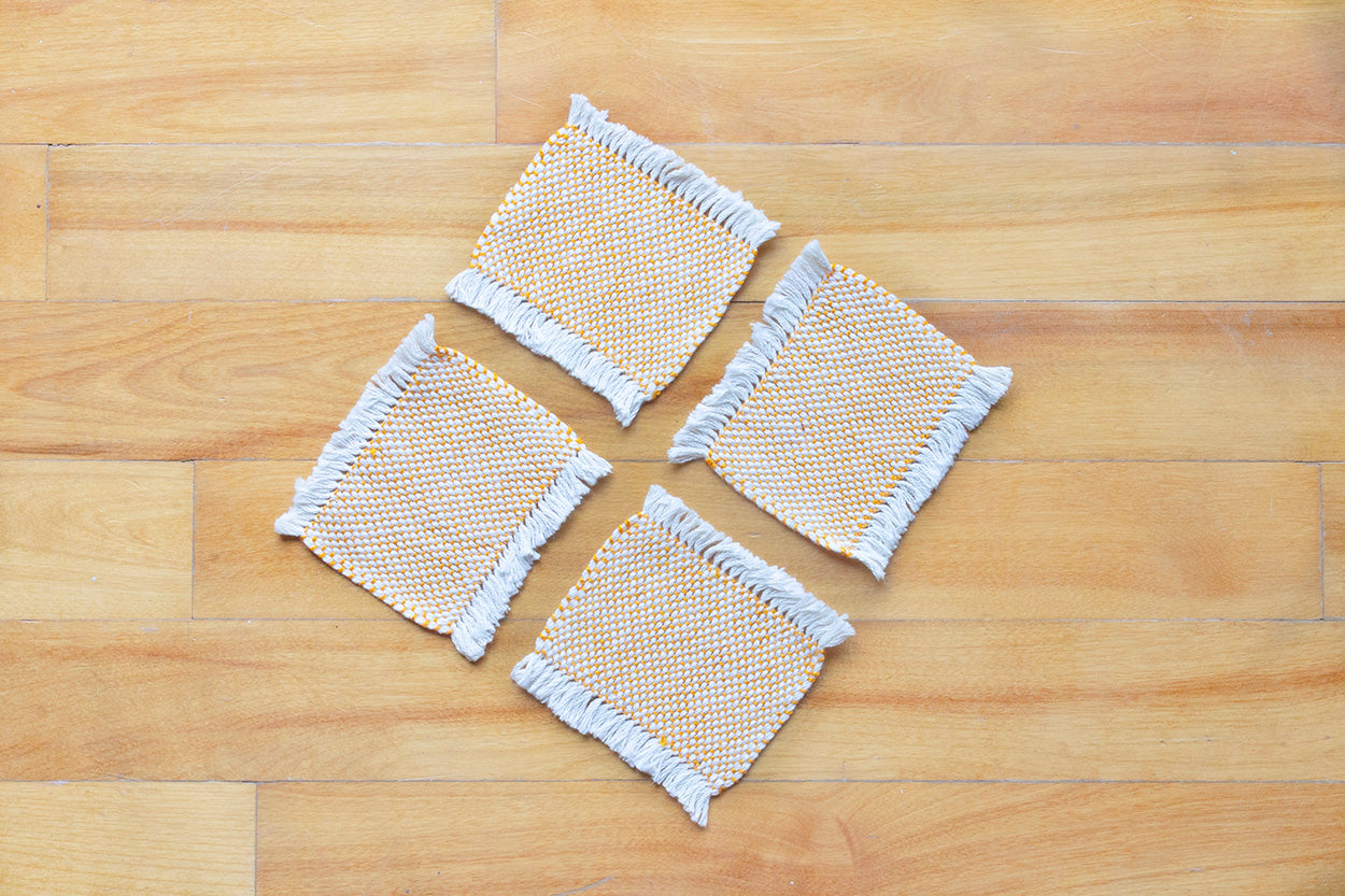 Cotton coasters, set of four, Pale Orange, Blue-grey, Brown, Bright Yellow, Bright Orange, Purple, handmade, natural fibres, hemstitched, made in Canada